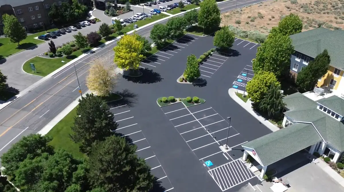 Aerial view of a freshly sealcoated and striped commercial hotel parking lot in Tri-Cities WA